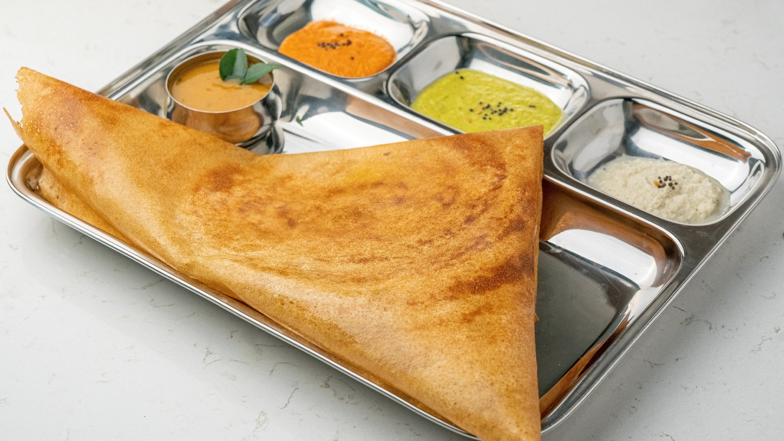 Masala Dosa stuffed with spiced potato filling served at Sangam Vegetarian Restaurant