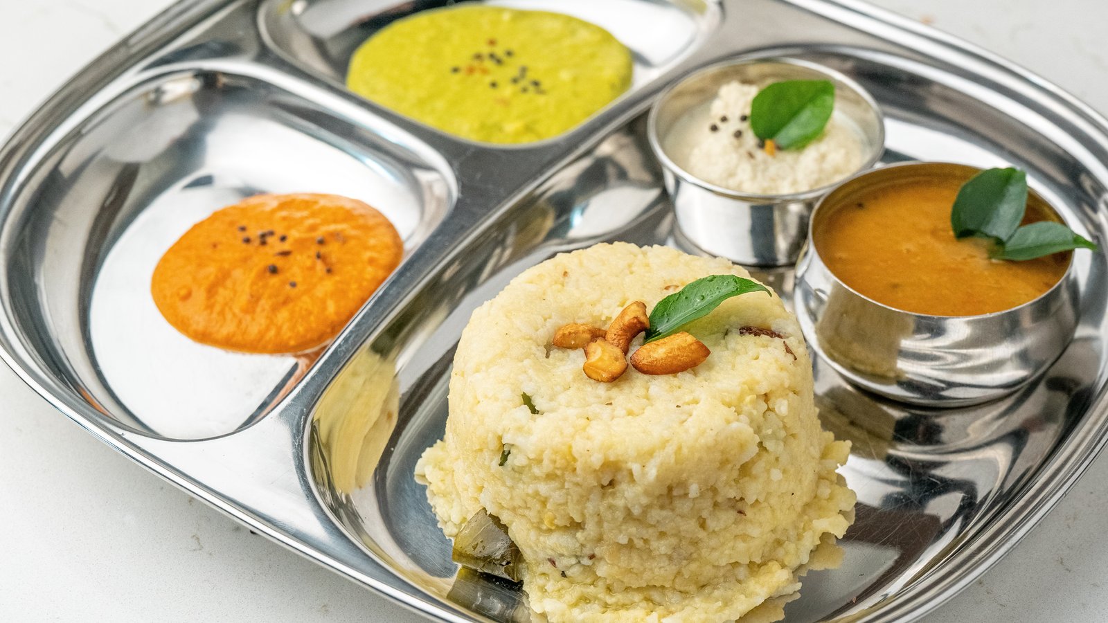 Creamy South Indian Pongal with lentils and rice served at Sangam Vegetarian Restaurant