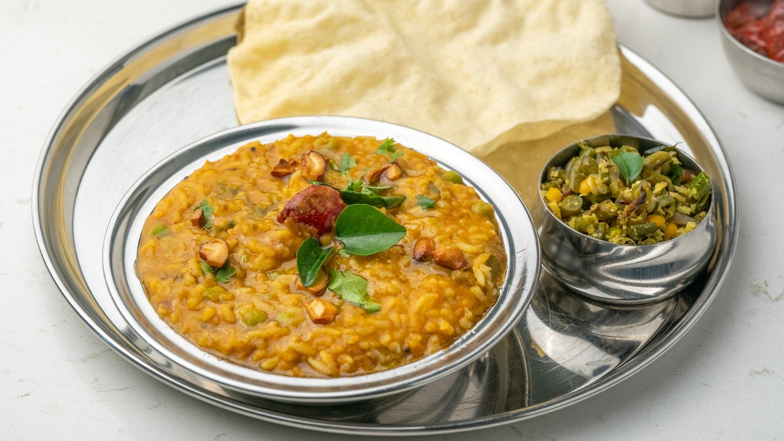 Aromatic Bisibele Bath with lentils, rice, and spices served at Sangam Vegetarian Restaurant