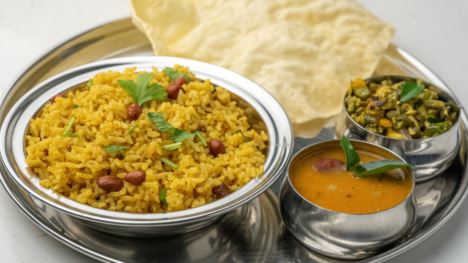 Tangy Tamarind Rice with spices and curry leaves served at Sangam Vegetarian Restaurant