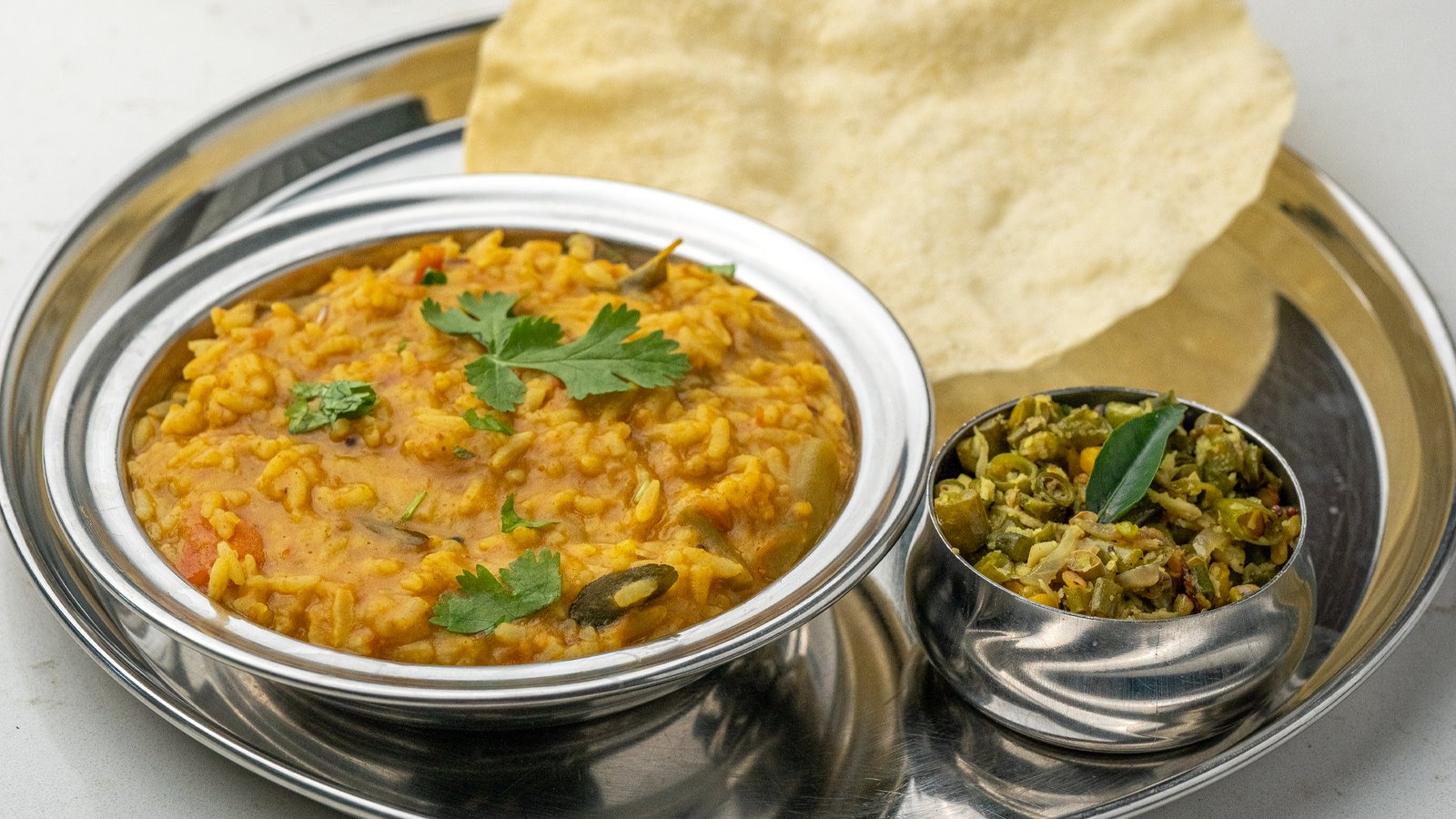 Steaming Sambar Rice with lentils and vegetables served at Sangam Vegetarian Restaurant