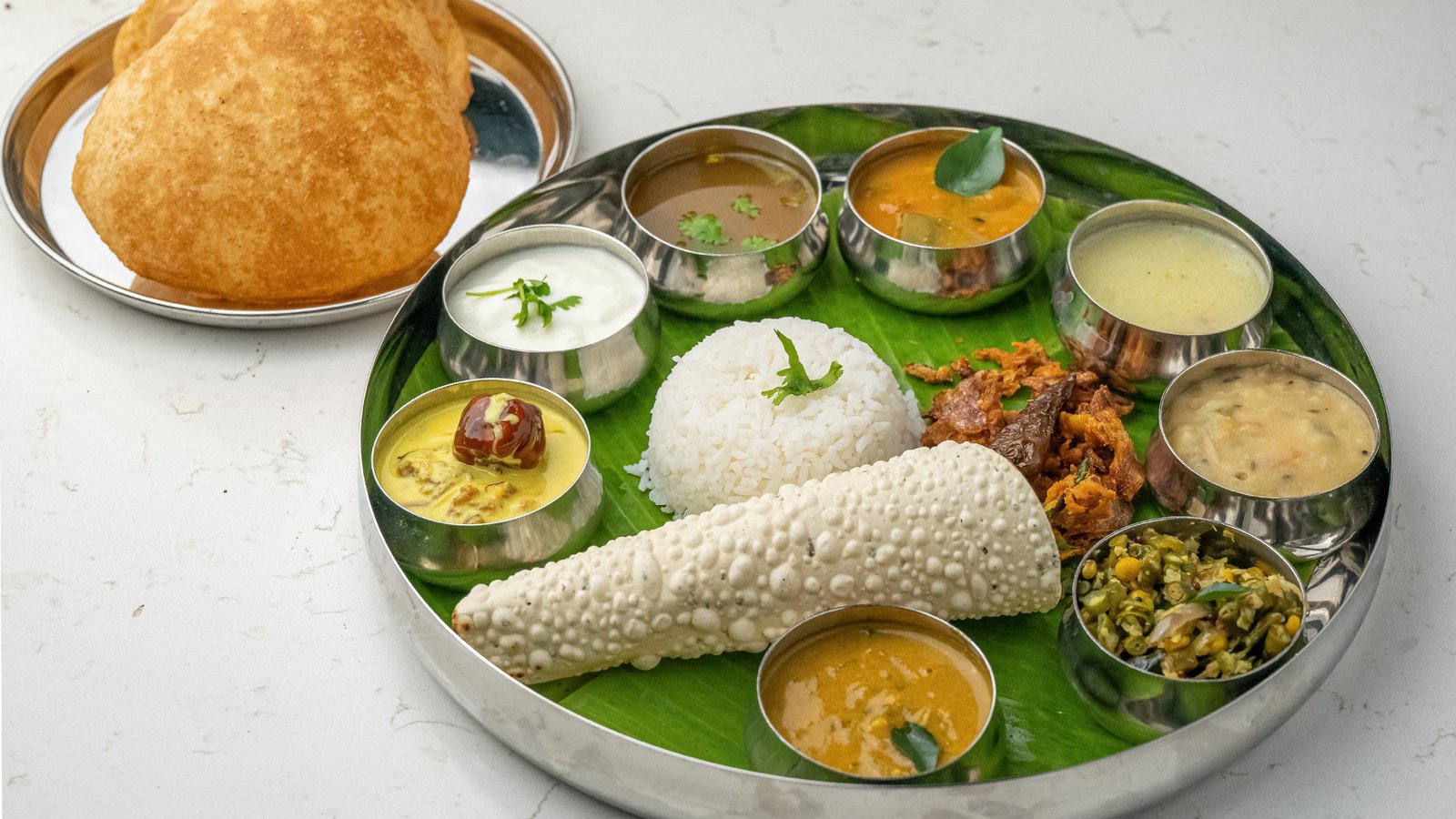 Traditional South Indian Thali with rice, curries, and accompaniments served at Sangam Vegetarian Restaurant